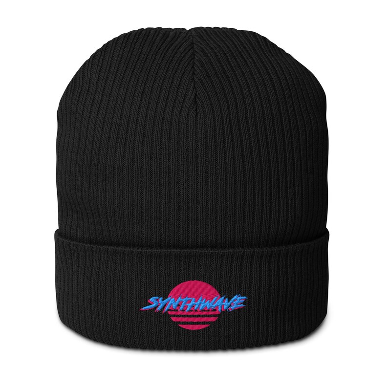 Classic ribbed beanie. Synthwave in retro front in bright blue with hot pink shadow over a sunset in hot pink.
6 colours available.
Oxford Navy
Black
Light Avio Blue
Light Grey
Leaf Green
Mustard Yellow.
Black shown.