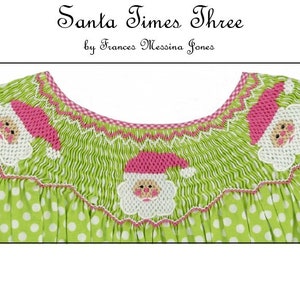 May include: A green polka-dot dress with smocking and Santa Claus appliqués. The dress features three Santa Claus designs with pink hats and white beards. The neckline is trimmed with pink and a gingham pattern. The text "Santa Times Three" is at the top.