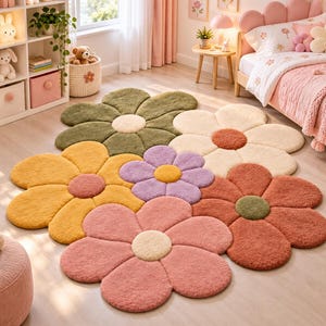 May include: A large, plush area rug shaped like a cluster of interconnected flowers. The rug features petals in various colors including olive green, cream, mustard yellow, lavender, dusty pink, and terracotta, with contrasting centers.