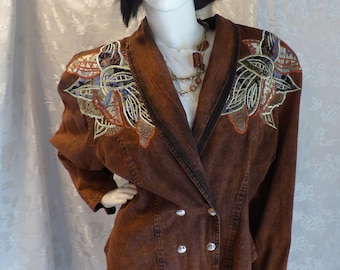 May include: A brown denim jacket with a double-breasted closure and embroidered floral details on the shoulders.