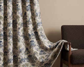 May include: A floor-length curtain featuring a blue and green toile pattern on a cream background. The print depicts traditional pagodas, arched bridges, willow trees, and small boats. The fabric hangs in vertical folds, partially draped over a chair.