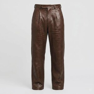 May include: Dark brown trousers featuring a textured crocodile skin pattern throughout. These trousers include a high-waisted design with a button closure, a front zip fly, and subtle pleats at the waistline, falling into a straight-leg silhouette.