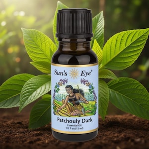 May include: A dark amber glass bottle with a black ribbed cap containing Sun's Eye Patchouly Dark essential oil. The label features a sun logo, the text Sun's Eye, Patchouly Dark, Essential Oil, and 1/2 fl oz (15 ml) with an illustration of a person.