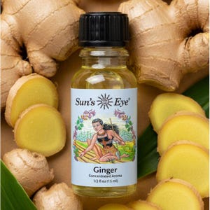 May include: A clear glass bottle with a black cap containing yellow liquid, labeled Sun's Eye Ginger Concentrated Aroma 1/2 fl oz (15 ml) with an illustration of a person in a field, surrounded by fresh ginger root pieces and slices.