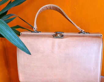 May include: A light brown leather vintage style doctor's bag with a brass clasp and handle.