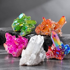 May include: A collection of five raw crystal clusters featuring a vibrant green specimen, a warm orange cluster, a bright magenta formation, a clear translucent quartz piece, and a multi-colored iridescent cluster with rainbow hues.