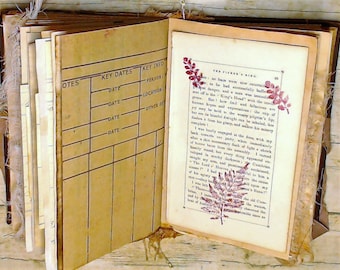 May include: An open vintage journal with brown leather covers and pages filled with handwritten notes. The pages are lined with a grid pattern and have a section labeled "Key Dates" and "Key Info".