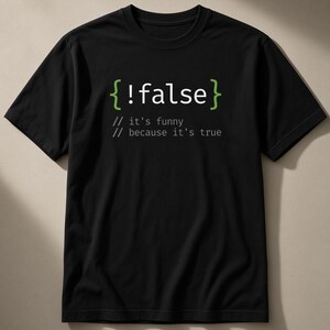 May include: A black short-sleeved t-shirt featuring a graphic print in white and light green. The design displays the code snippet { !false } followed by two lines of comment text that read // it's funny // because it's true.