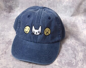 Happy sad cat face embroidered vintage style blue baseball cap