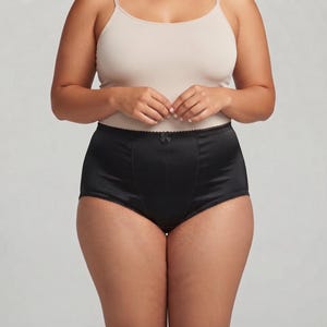 May include: High-waisted black briefs featuring a smooth, satin-like finish with a central vertical seam and a small decorative bow at the center of the waistband. The garment has a scalloped trim along the leg openings and the top edge.