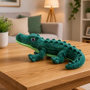 May include: A dark green crochet alligator plush toy with a light green underbelly and textured scales along its back. The stuffed animal features large, round, dark purple eyes and a detailed snout, crafted from soft, plush yarn material.