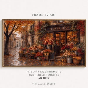 Pode incluir: Uma obra de arte digital para Frame TV retratando a fachada de uma floricultura no outono. A cena apresenta uma rua de paralelepípedos, uma grande árvore com folhas alaranjadas e inúmeras flores em vasos de tons quentes. Texto: FRAME TV ART.