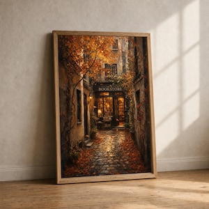 May include: A framed vertical wall art print depicting a narrow cobblestone alleyway leading to a bookstore entrance. The scene is filled with warm autumn foliage, orange leaves on the ground, and glowing interior lights visible through the glass.