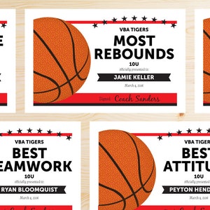 May include: Four basketball-themed award certificates with black and red borders. Each certificate features a basketball graphic and text that reads "VBA Tigers" and the award name, such as "Most Rebounds" or "Best Teamwork". The certificates are presented to Jamie Keller, Ryan Bloomquist, and Peyton Hendricks.