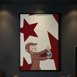 May include: A framed wall art print featuring a cartoon brown monkey holding a small grey camera. The background is a cream color with large, dark red star shapes. The monkey has a smiling expression and is looking toward the camera lens.