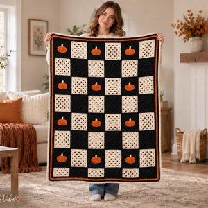 May include: A rectangular crochet blanket featuring a checkerboard pattern of solid black squares and cream-colored squares. Each black square contains a small, orange crocheted pumpkin motif. The blanket is finished with a thin orange and black border.