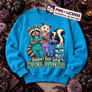 May include: A bright blue sweatshirt featuring a graphic of a raccoon, an opossum, and a skunk dressed in medical scrubs. The raccoon wears teal scrubs, the opossum wears purple, and the skunk wears blue. Text reads: Support Your Local MEDICAL ASSISTANTS.