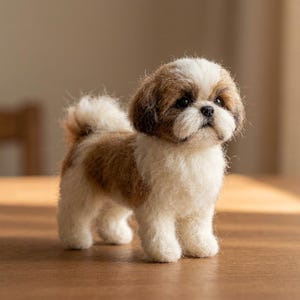 May include: A needle-felted Shih Tzu dog figurine with a fluffy texture. The dog has a white chest, legs, and muzzle, with brown patches on its ears, back, and tail. It features dark, round eyes, a small black nose, and a curled, upright tail.