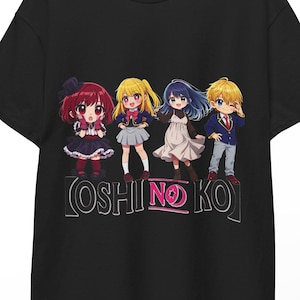 May include: A black short-sleeved t-shirt featuring a graphic print of four chibi-style anime characters standing in a row. Below the characters, the text OSHI NO KO is printed in a stylized font with a pink accent on the word NO.