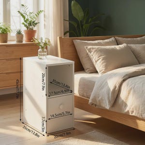 May include: A white bedside table with an open shelf and a single drawer featuring a round knob. The unit measures 17.7 inches in height, 13.8 inches in depth, and 7.9 inches in width. The drawer front is 5.7 inches wide and 3 inches high.