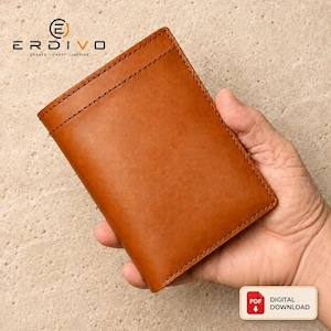 May include: A tan leather wallet featuring visible stitching along the edges. The top left corner displays the text ERDIVO CREATE CRAFT INSPIRE with a circular logo. A small rectangular label in the bottom right corner reads PDF DIGITAL DOWNLOAD.