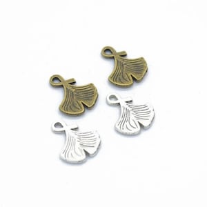 May include: Four ginkgo leaf charms, two in antique bronze and two in silver. The charms have a loop at the top for attaching to jewelry or other crafts.