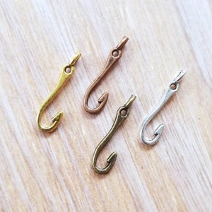 May include: Four metal fishing hook charms in gold, silver, and bronze.