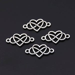 May include: Four silver-toned metal charms in the shape of an infinity symbol intertwined with a heart. The charms have two small loops on either side for attaching to jewelry or other crafts.
