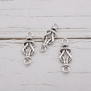 May include: Three silver-toned metal connector charms with a knot design. Each charm has two loops for attaching to jewelry.