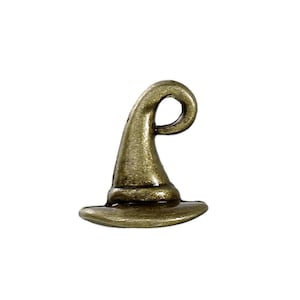 May include: A bronze-colored witch hat charm with a curled top and a wide brim. The charm is made of metal and has a vintage or antique appearance. The hat is a classic Halloween or fantasy-themed accessory.