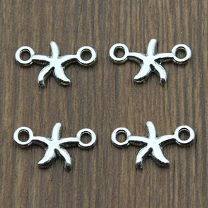 May include: Four silver-toned starfish charms with two jump rings on each charm. The charms are perfect for adding a nautical touch to jewelry projects.