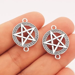 May include: Two silver-toned metal charms featuring a pentagram design within a circle of braided rope. The charms have a loop at the top and a jump ring at the bottom.