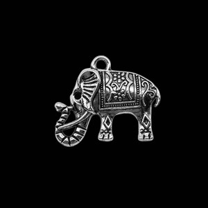 May include: Silver charm in the shape of an elephant with intricate floral designs. The elephant has a raised trunk and a loop at the top for attaching to a necklace or bracelet.