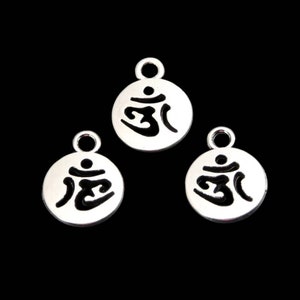May include: Three silver charms with an Om symbol cut out in the center. The charms are round and have a loop at the top for attaching to a necklace or bracelet.