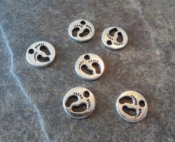 10 Tiny Baby Feet Charms Round Silver Charms With Cut Out