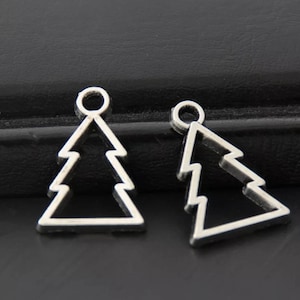 May include: Two silver metal Christmas tree charms with a loop at the top for hanging. The charms are in the shape of a simple Christmas tree outline.