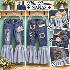 May include: Blue denim jeans featuring light blue fabric bell-bottom ruffles, crochet lace patches, and floral embroidery. The jeans include distressed areas, frayed edges, and decorative fabric strips. The design incorporates various textures and patterns.