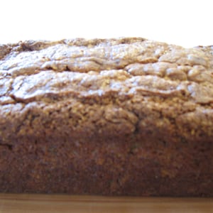 May include: A loaf of freshly baked banana bread with a golden brown crust.