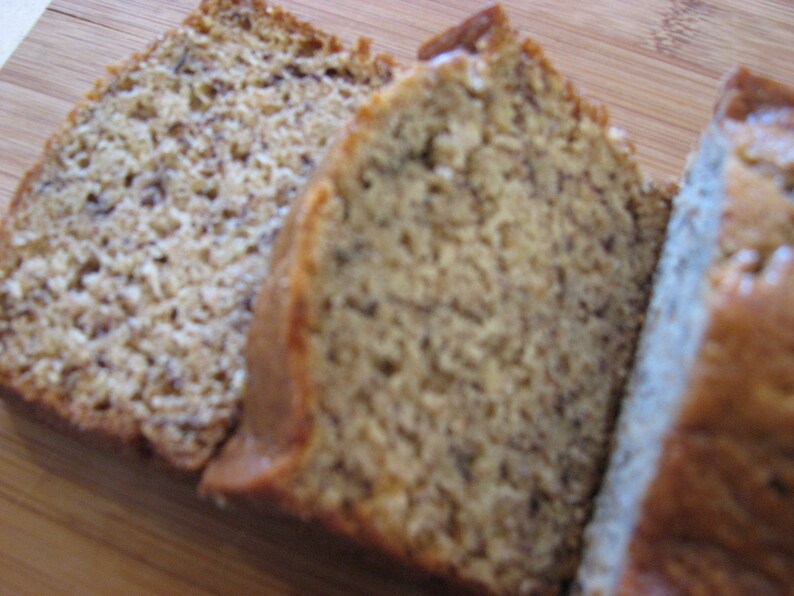 May include: Three slices of banana bread, each with a different texture and color. The bread is light brown and has a slightly crumbly texture.