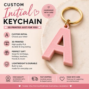 May include: A light pink 3D printed letter A keychain with a gold-toned metal ring. The image includes text: CUSTOM Initial KEYCHAIN, 3D PRINTED JUST FOR YOU, CUSTOM INITIAL, 3D PRINTED, PERFECT GIFT, LIGHTWEIGHT & DURABLE, HANDMADE WITH CARE.