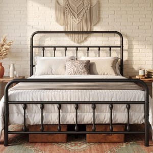 May include: A black metal bed frame featuring a rounded headboard and footboard with vertical spindle detailing. The frame is dressed with a white quilted comforter and several pillows, including one with a brown and white zebra-like pattern.