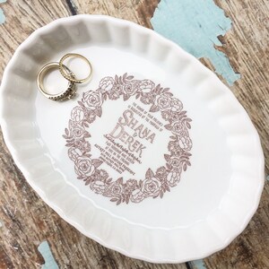 May include: White ceramic ring dish with a brown floral design and the text "The honor of your presence is requested at the marriage of Shana & Derek Saturday the Eighth of October Two Thousand and Sixteen at five in the evening Autrey Mill Nature Preserve 977 Autrey Mill Road Johns Creek, GA 20023"
