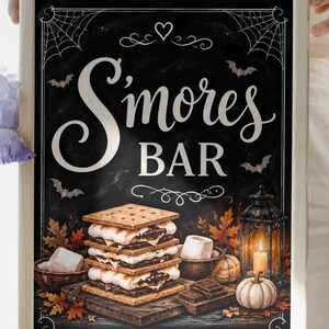 May include: A framed chalkboard sign with the text S'mores BAR in white script and block lettering. The design features spider webs, bats, a heart, a stack of s'mores, autumn leaves, a lit lantern, pumpkins, and chocolate squares.