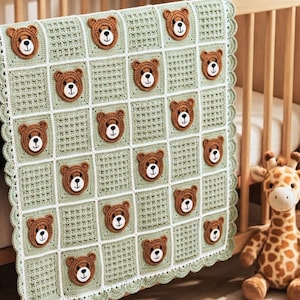 May include: A sage green crochet blanket featuring a grid of squares, with alternating squares displaying a brown bear face appliqué. The blanket has a white grid border and a scalloped edge, with each bear face having black eyes and a nose.
