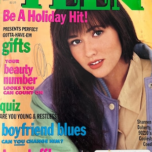 May include: A December 1991 issue of 'TEEN magazine featuring Shannen Doherty on the cover. The cover displays the text 'Be A Holiday Hit!', 'Your beauty number', 'Are you young & restless?', and 'boyfriend blues'. The subject wears a purple and green jacket.