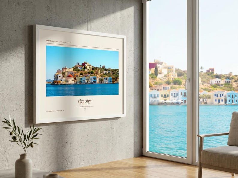 May include: A framed horizontal wall art print featuring a vibrant photograph of colorful Mediterranean coastal buildings along a blue harbor. The print includes the text Kastellorizo, Yunanistan at the top and the phrase siga siga at the bottom.