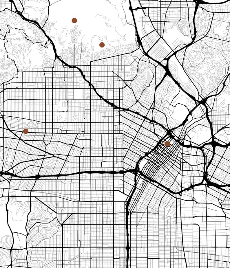 May include: A black and white street map print featuring a dense grid of roads and highways. Four solid brown circular markers are placed at specific locations across the urban layout, highlighting points of interest on the white background.