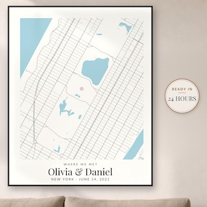 May include: A framed map print featuring a grid of city streets, light blue water bodies, and a red location marker. Text reads: WHERE WE MET, Olivia & Daniel, NEW YORK, JUNE 14, 2021. A circular badge on the right states: READY IN 24 HOURS.