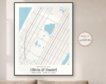 May include: A framed map print featuring a grid of city streets, light blue water bodies, and a red location marker. Text reads: WHERE WE MET, Olivia & Daniel, NEW YORK, JUNE 14, 2021. A circular badge on the right states: READY IN 24 HOURS.
