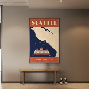 May include: A rectangular wall poster featuring a stylized graphic of a ferry on dark blue water against a cream background. The top orange banner displays the text SEATTLE in white, and the bottom orange banner reads PUGET SOUND FERRY.
